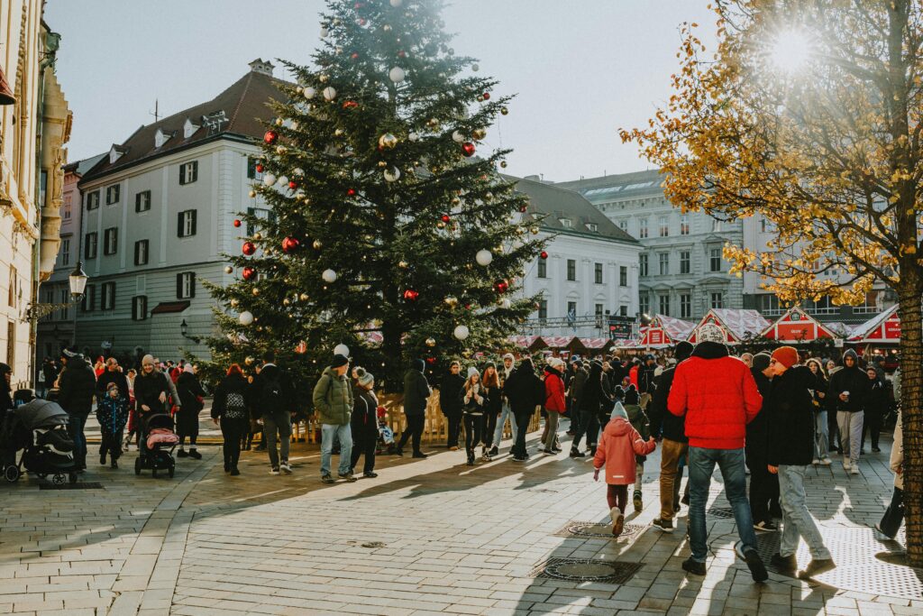 a city center with a christmas tree and christmas market